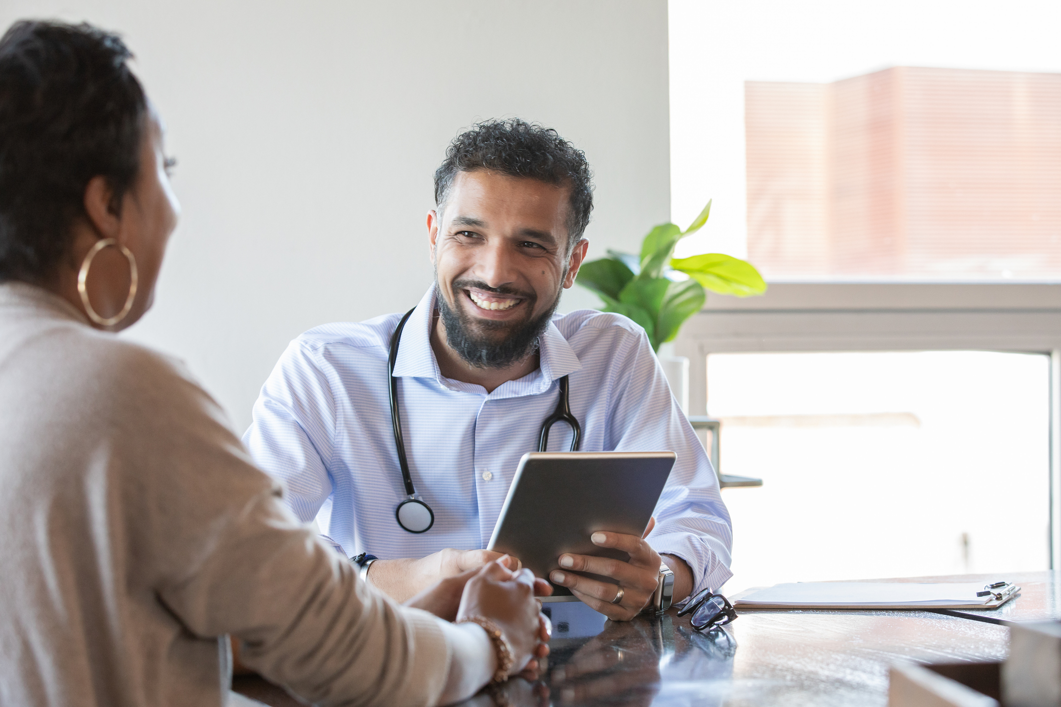 A GP in consultation with a patient.